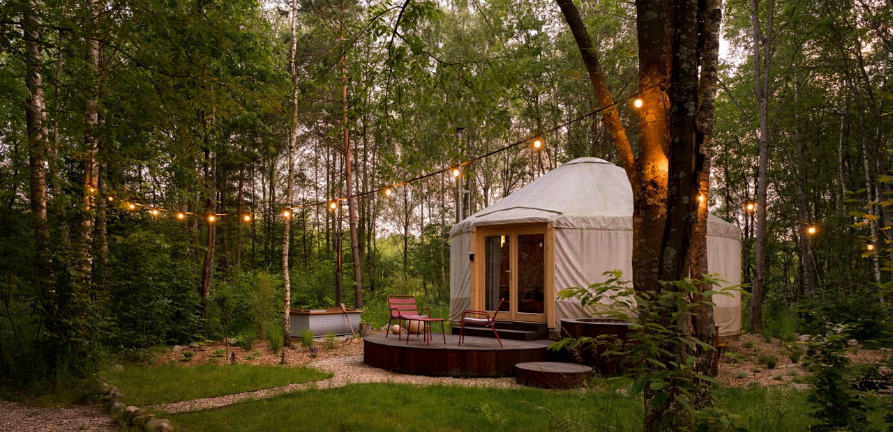 Beautiful yurt tent for glamping style holiday with charming decorations in green forest