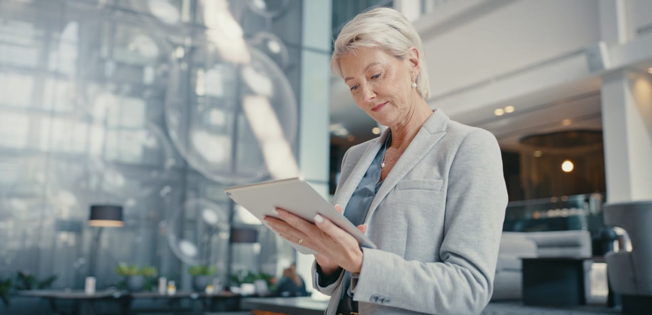 Businesswomen reviewing a tablet in an office.